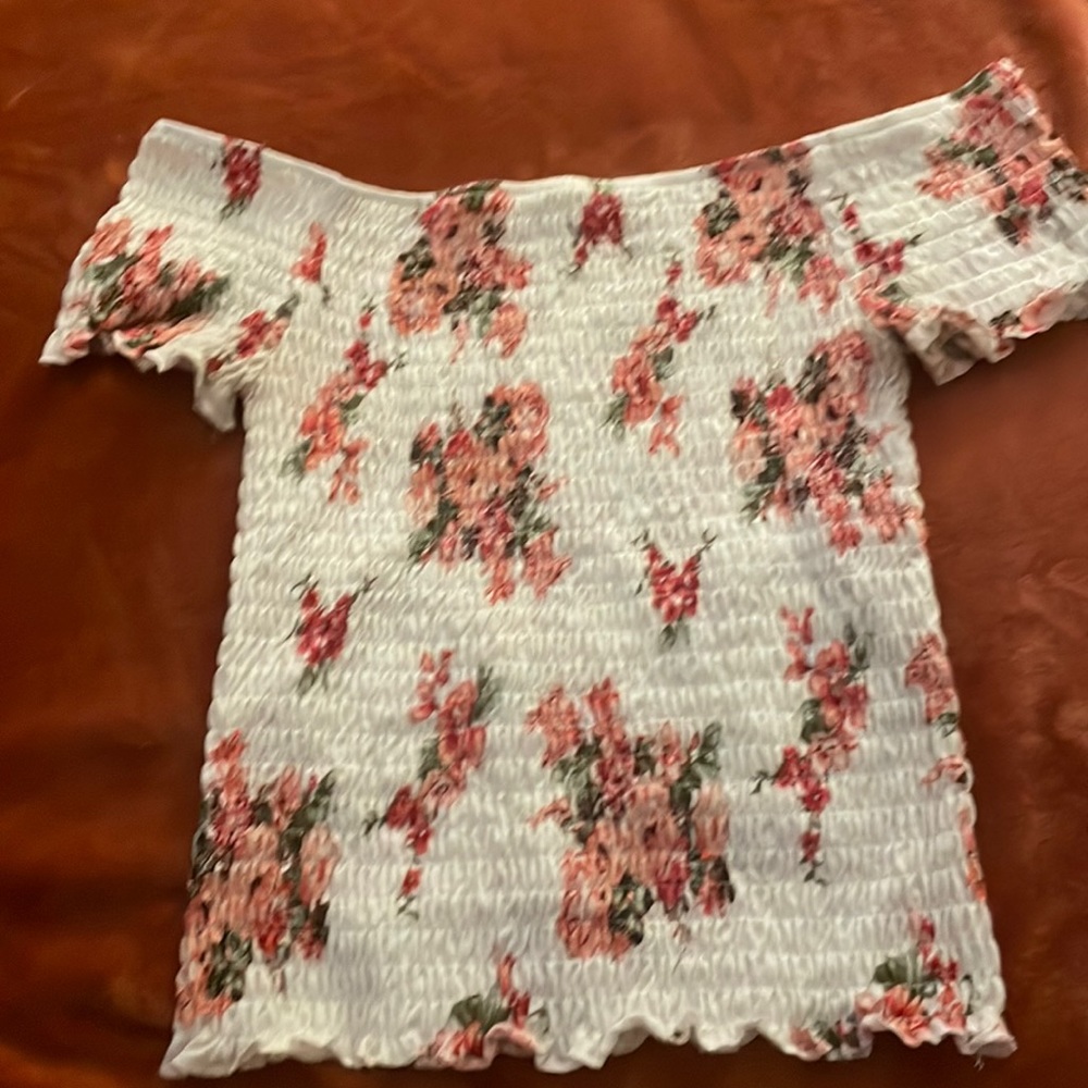 Off the shoulder white and pink floral blouse.